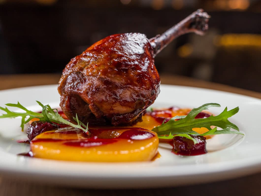 Duck confit on white plate, restsurant